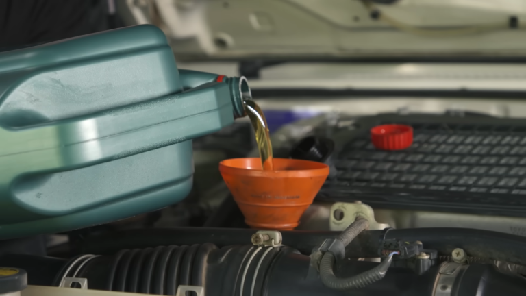 Pouring New Car’s Oil Into the Engine Through a Funnel