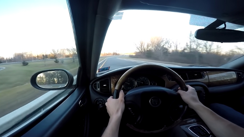 A Person Driving a Used Car on A Road During a Test Drive