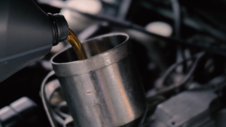 Image showing oil being poured into a car's engine, highlighting the process of oil changes in electric cars