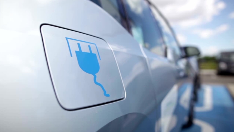 Image of an electric vehicle charging port, emphasizing the low-maintenance nature of electric cars