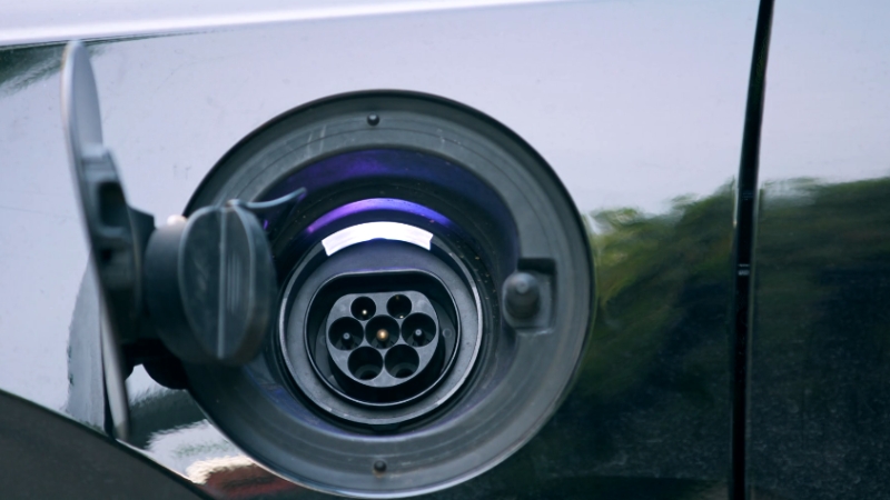 The image shows the charging port of an electric vehicle