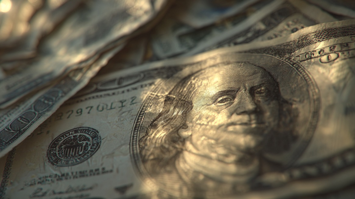 Close-up of U.S. hundred-dollar bills with Benjamin Franklin’s portrait in focus, symbolizing oil change costs
