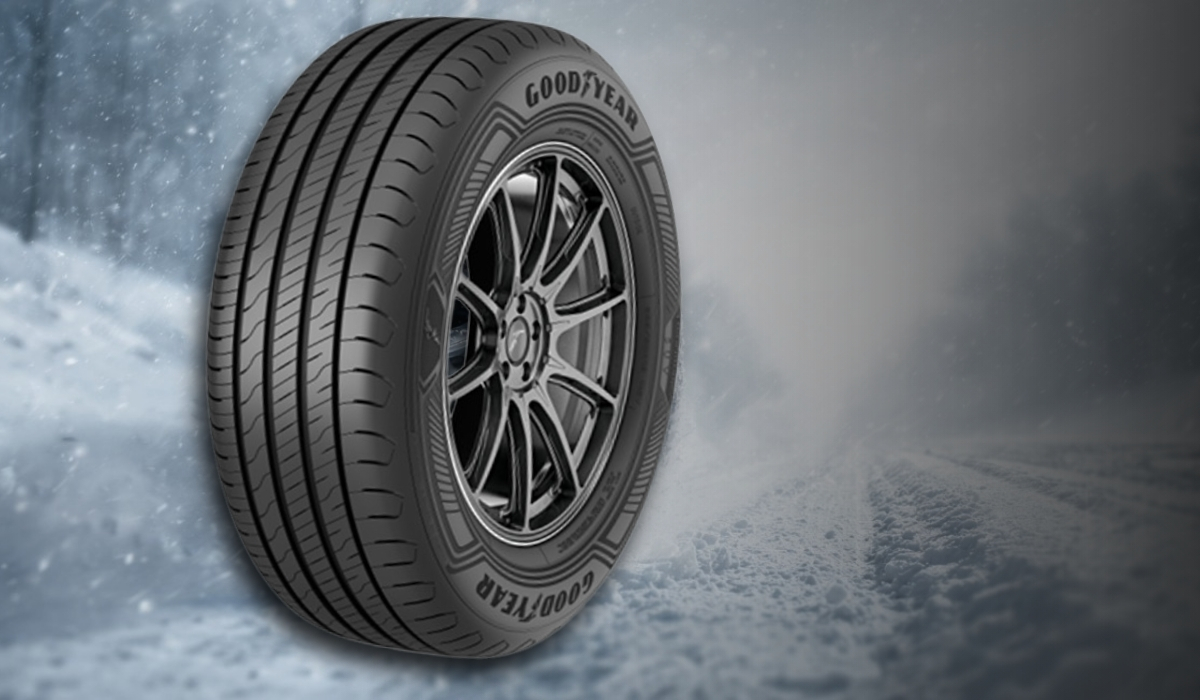 Goodyear winter tire with directional tread on a snowy road background