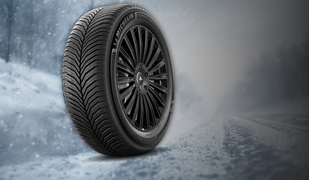 Michelin winter tire with V shaped tread pattern on a snowy road background