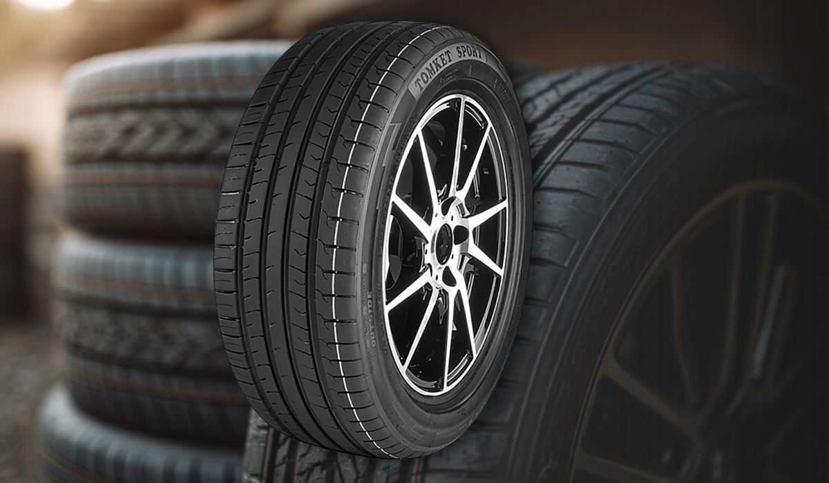 Close up of stacked car tires with alloy wheel in front