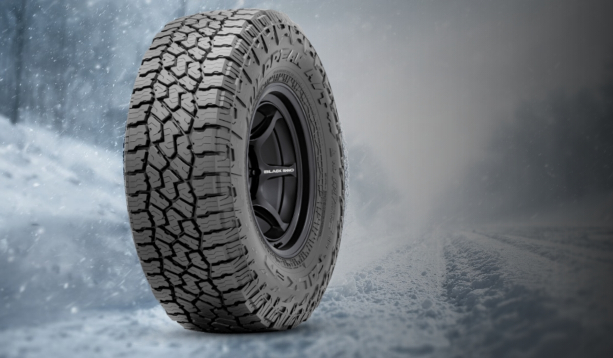 Aggressive winter tire tread designed for snow and ice on a frozen road background