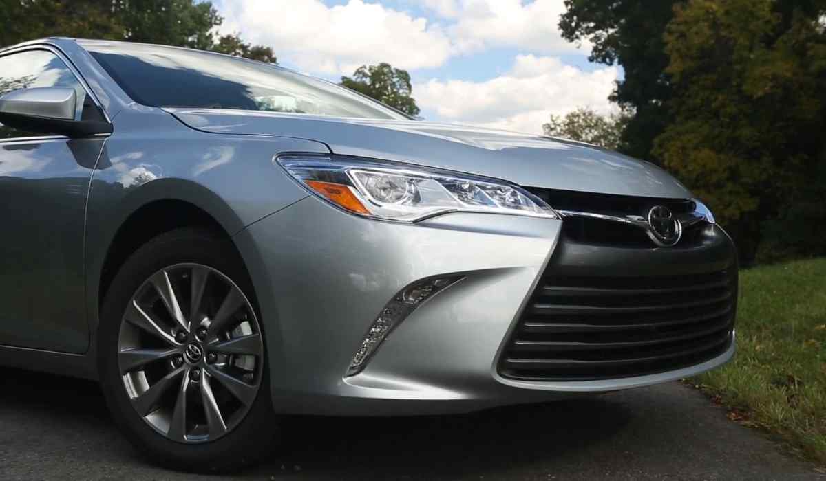 Front view of a silver Toyota Camry with updated grille and headlights parked outdoors