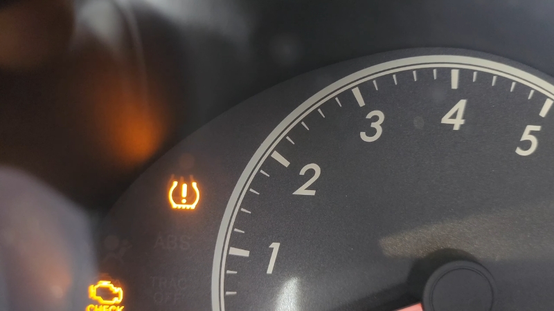 Dashboard with tire pressure light on while driving indicating low tire pressure warning