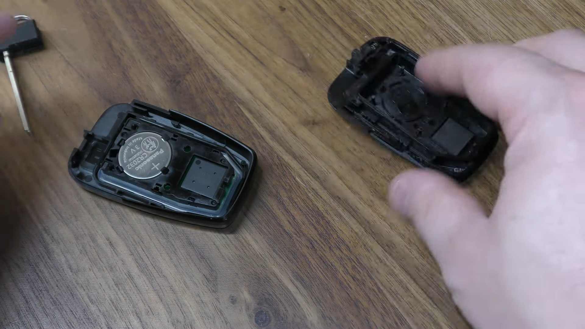 New CR2032 coin battery installed inside an opened Prius key fob