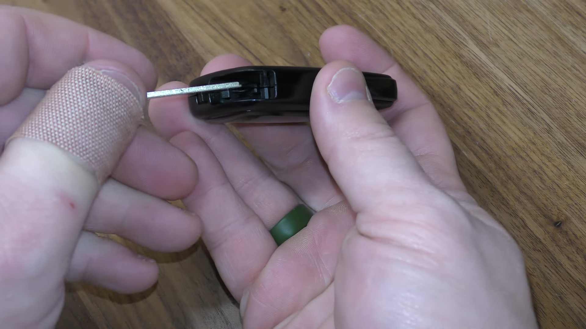 Person pulling the mechanical key out of a Prius smart key fob