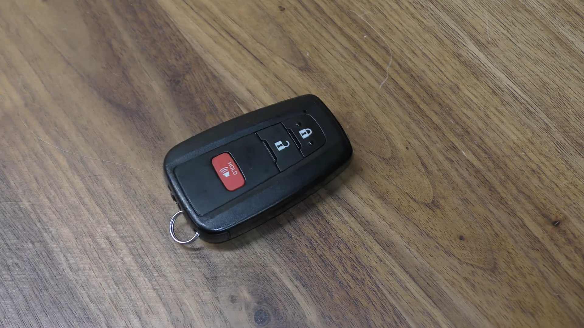 Fully reassembled Prius smart key fob resting on a wooden surface
