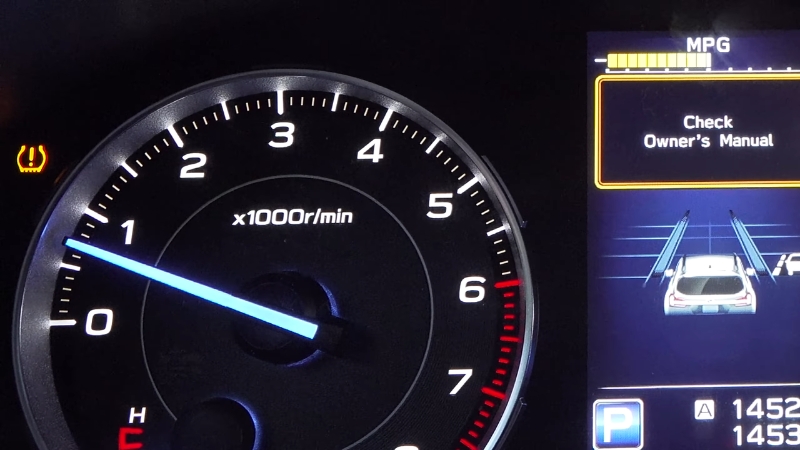 Dashboard with tire pressure light warning on and message to check owner’s manual